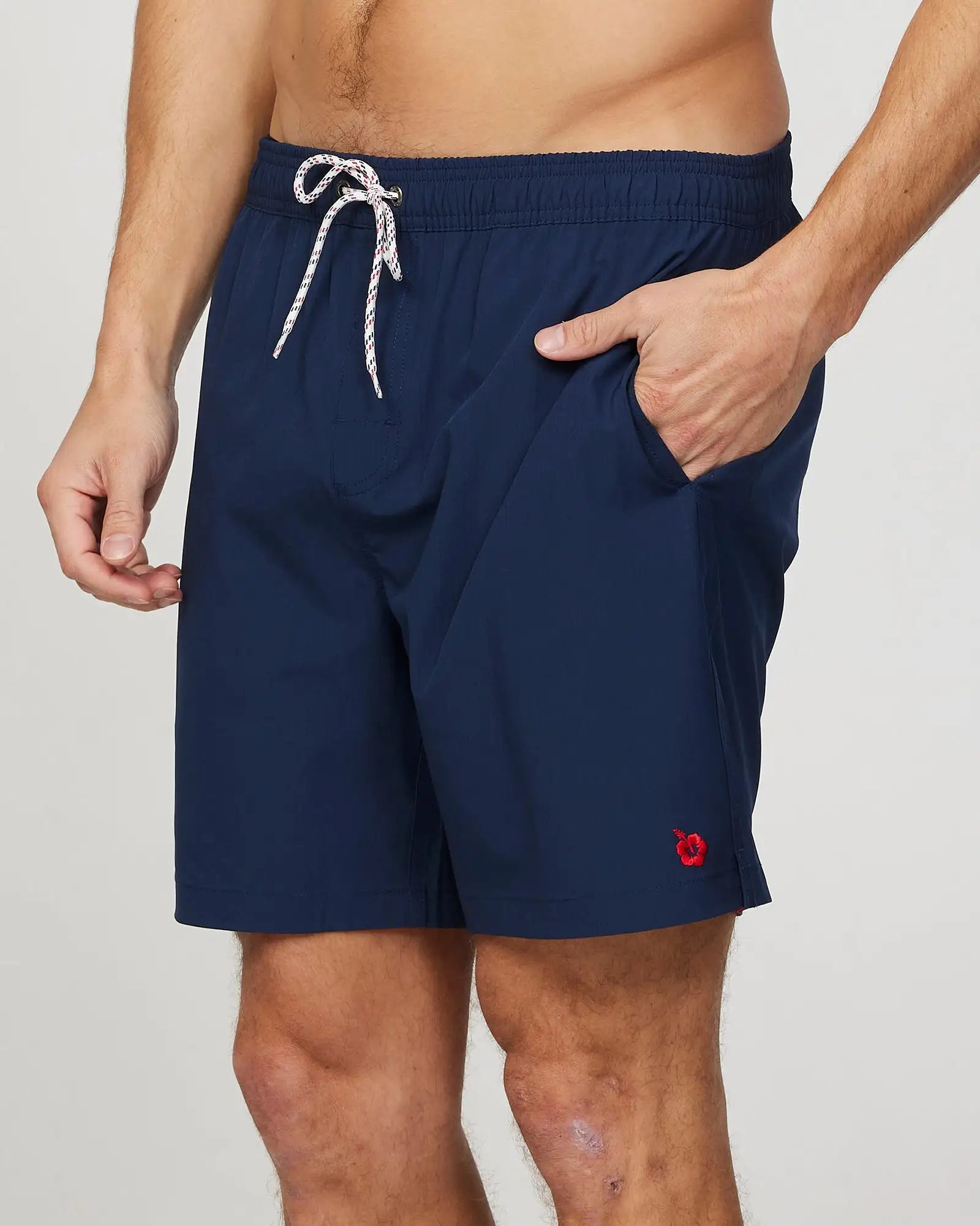 Hand in pocket of a male model wearing the Okanui Mens Onboard stretch swim short in Navy