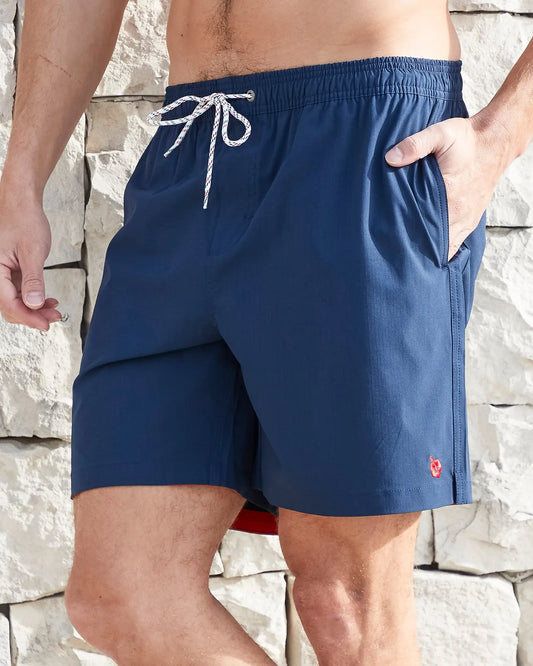 Left side view of the Okanui Mens Onboard stretch swim short in Navy