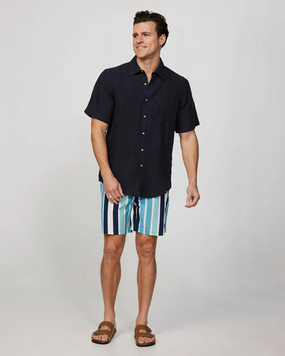 Full body front view of a male model wearing the Okanui Mens Straight Lines Stretch Swim Short in Stone Multi