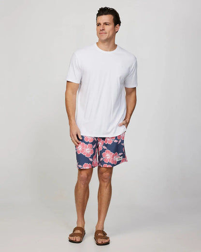 Full body front view of a male model wearing the Okanui Mens Stretch Swim Short in Iron Pink