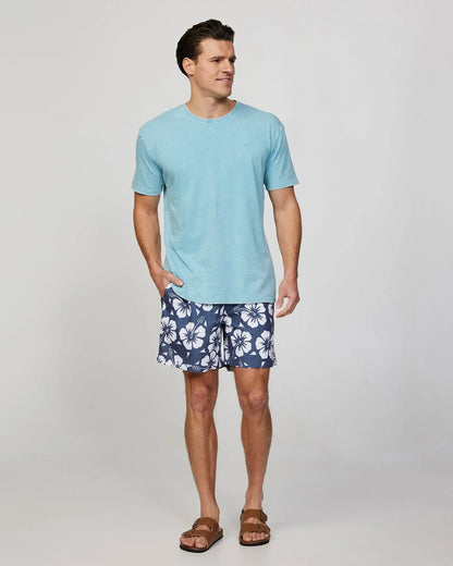 Full body front view of the Okanui mens classic swim short in hibiscus iron