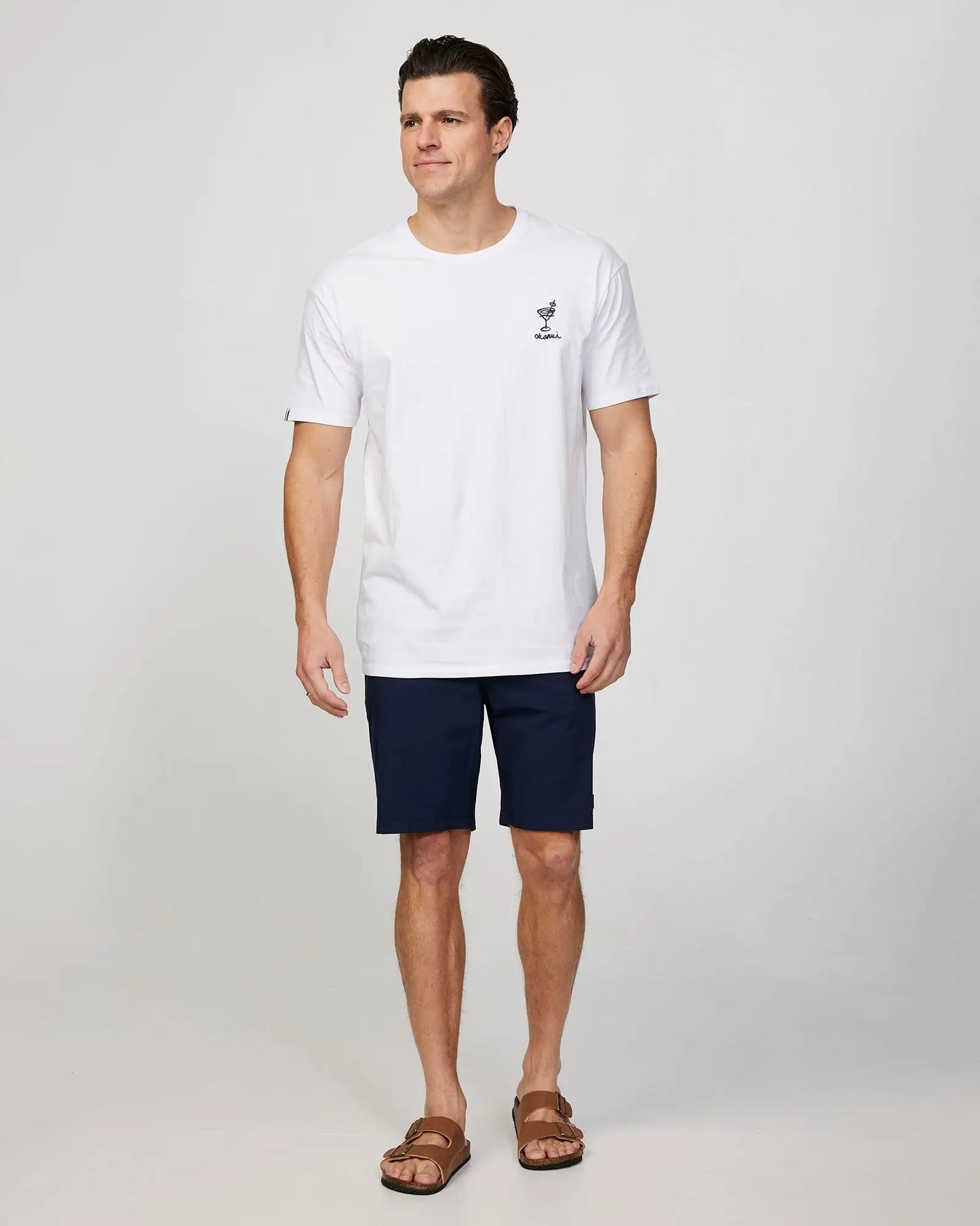 Full body front view of a male model wearing the Okanui Cruise Tee T-shirt in White