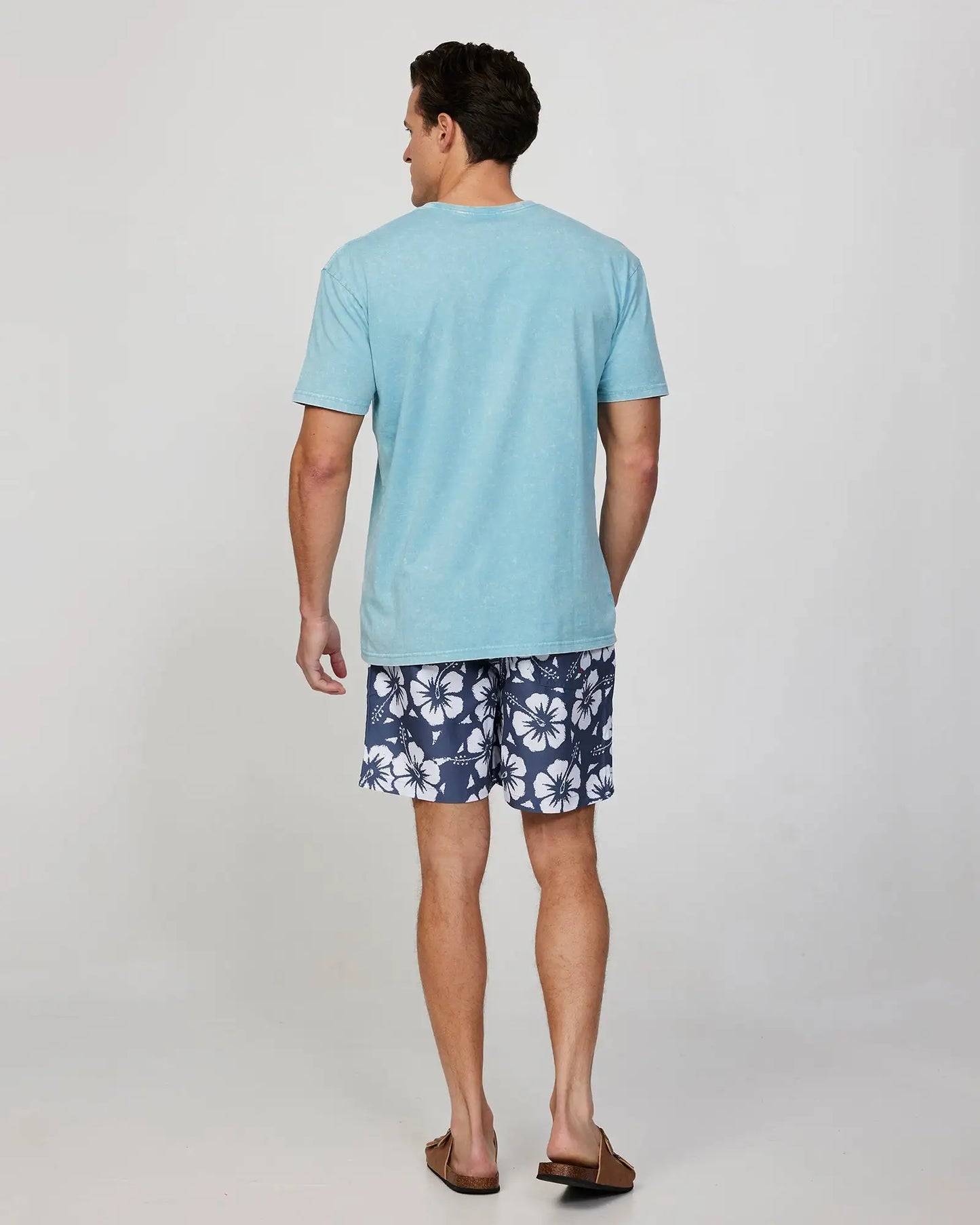 Full body back view of a male model wearing the Okanui Mens Staple Tee T-shirt in Seafoam