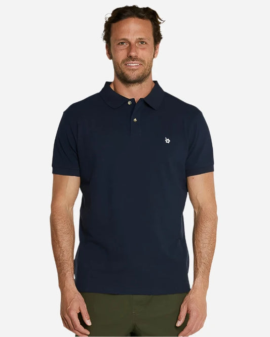 A model wearing the Okanui Classic Polo Shirt in navy color.