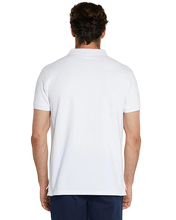 Back view of a male model wearing navy shorts and the Okanui Classic Polo Shirt in white.