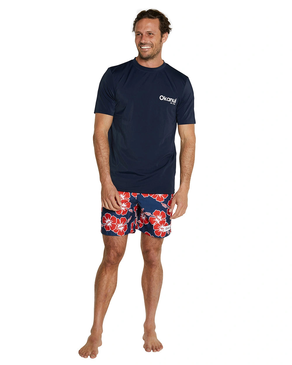 The Okanui Men's Classic Short Sleeve rashie in navy color with front chest print. 