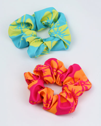 Okanui hair scrunchie in aqua at the top and an Okanui hair scrunchie in pink at the bottom