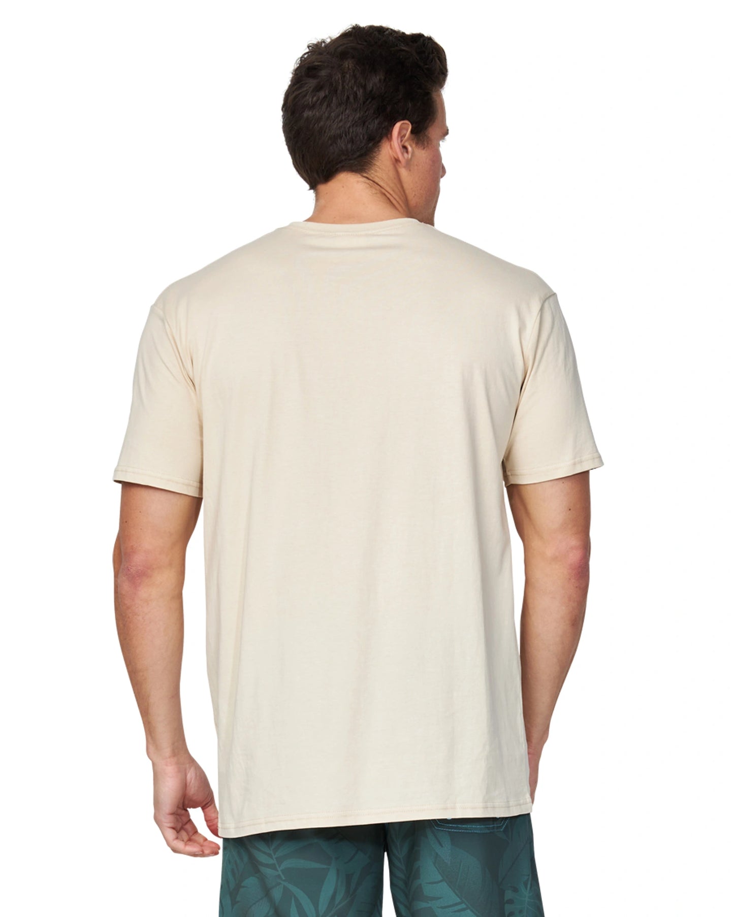 A back angle of a male model wearing the Okanui Men's Logo Tee in birch color.