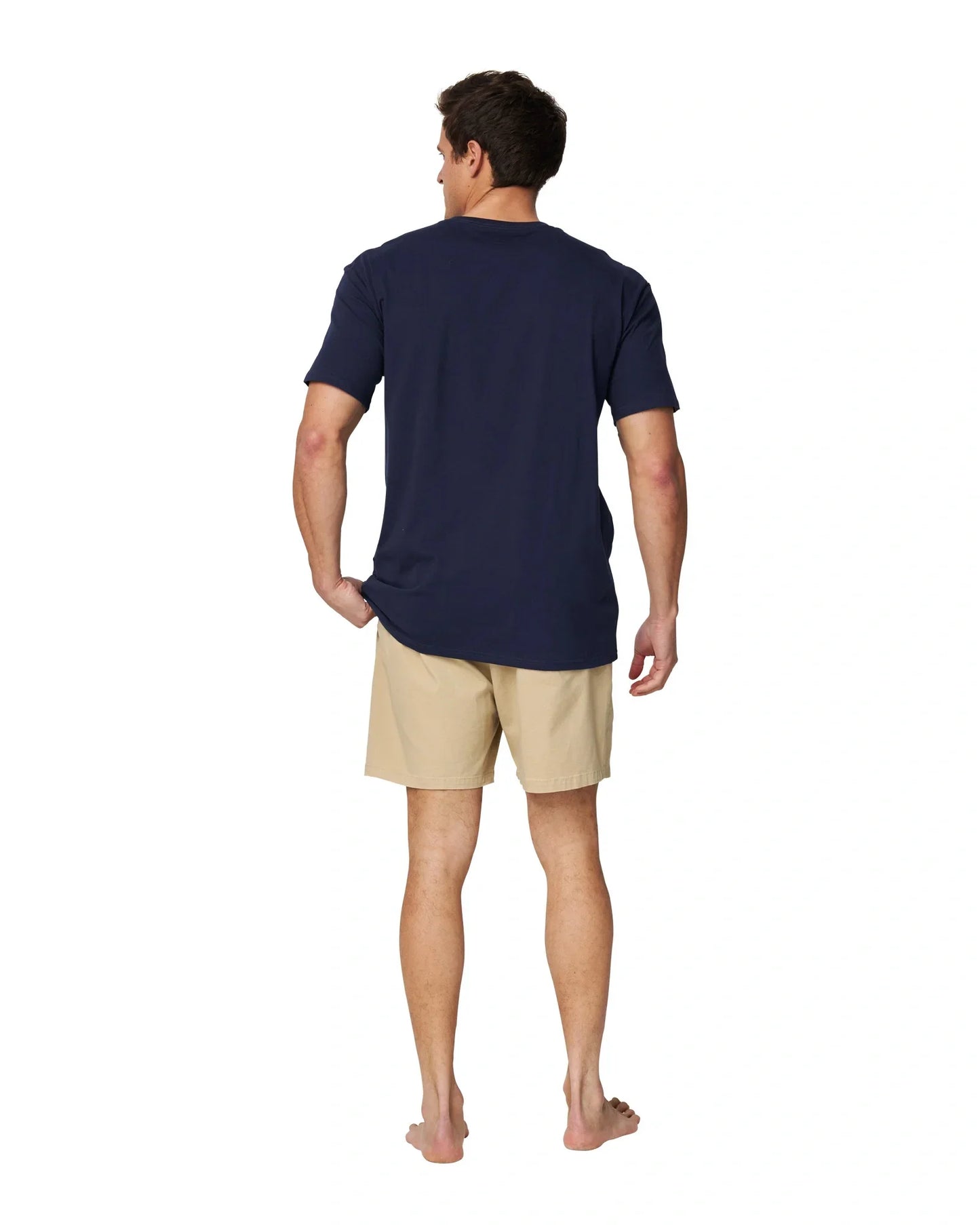 A full body back view of a male model wearing the Okanui Logo Tee in black.