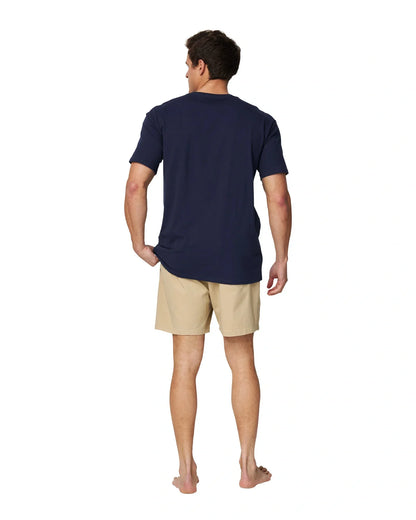 A full body back view of a male model wearing the Okanui Logo Tee in black.