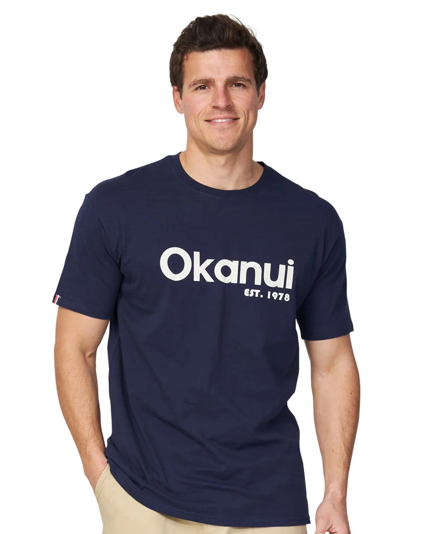 A male model wearing the Okanui Logo Tee in black.
