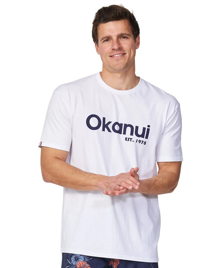 A male model wearing the Okanui Logo Tee in white.