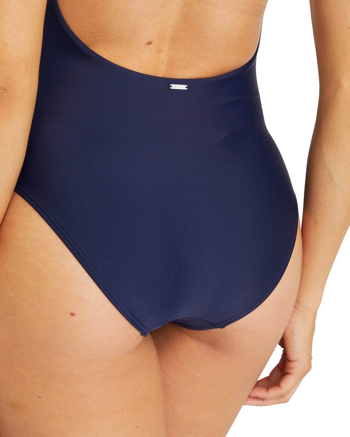 Close up view of the  Okanui crossover one piece swimsuit in Navy