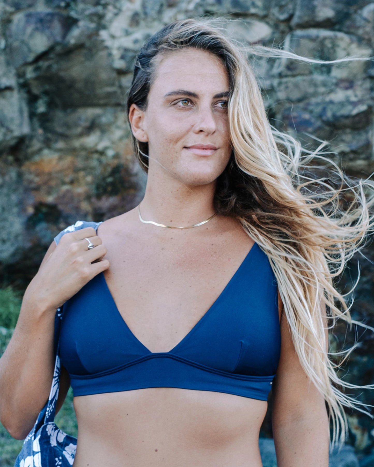 Close up front view of a female model wearing the Okanui womens trapezium triangle bikini top in Navy