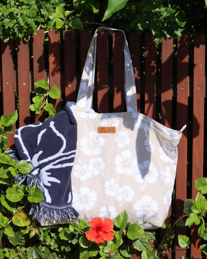  Okanui Beach Tote Bag in Hibiscus Stone color hang in the fence