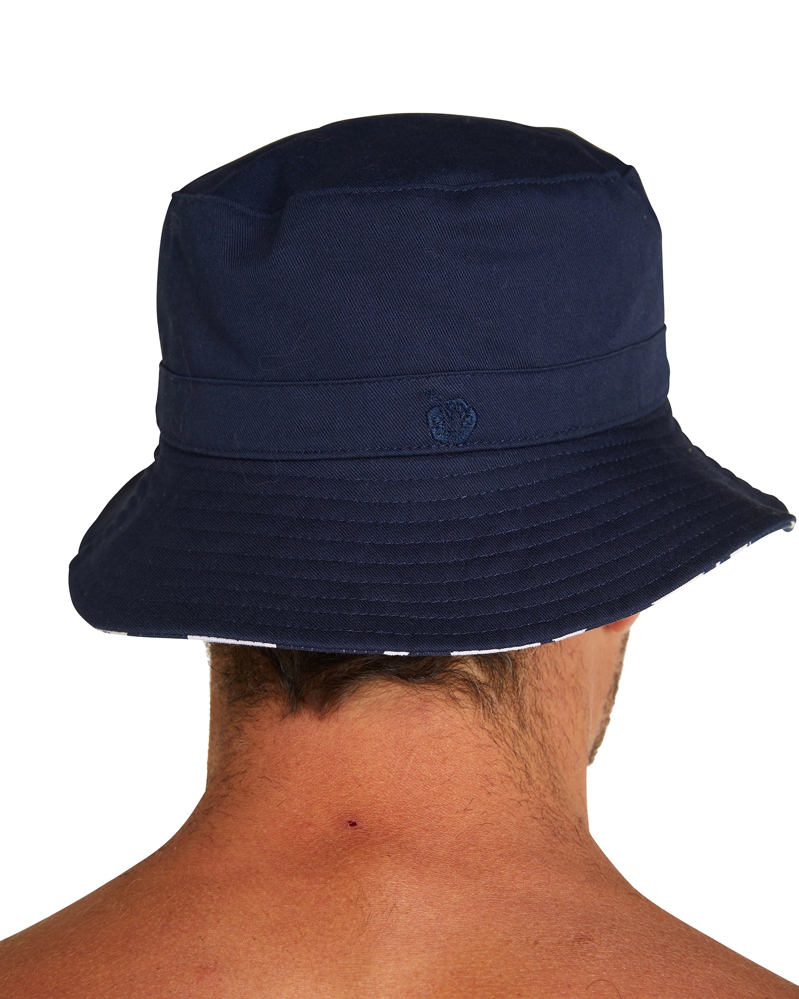 Back view of the Okanui Reversible Bucket Hat featuring an embroidered logo worn by a model.