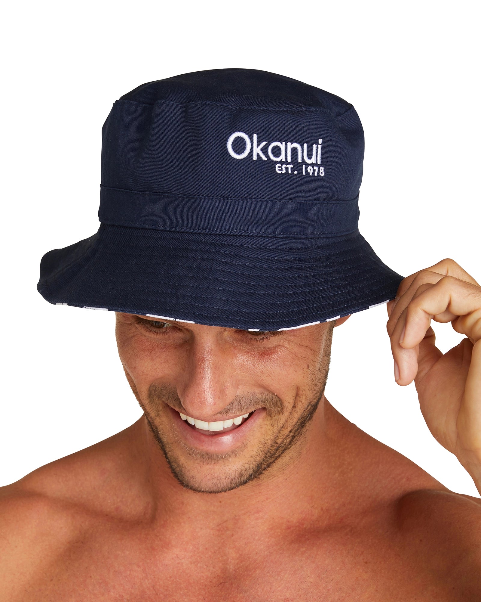 Another angle of the Okanui Reversible Bucket Hat worn by a male model.