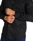 Much closer view of the Okanui Autumn Linen long sleeve shirt in black featuring the buttons.