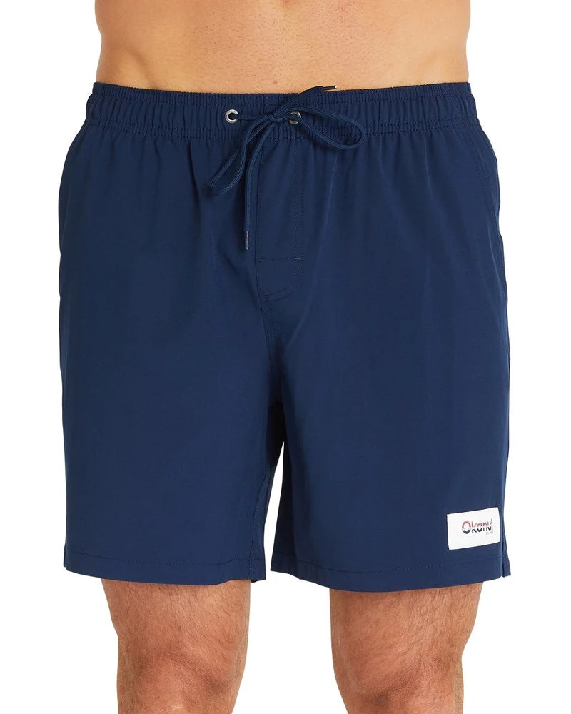 A close up front view of the Okanui Classic Plain Swimshort for men in navy color featuring a navy drawcord, the patched Okanui logo, and its elastic waist.